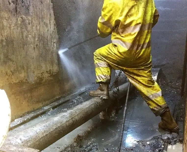The underground oil tank is being accessed with safety protocols and personal protective equipments (PPE)